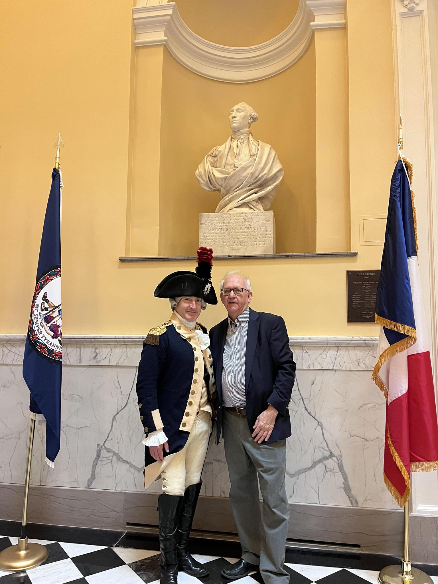 Photograph of Bruce E. Mowday with Lafayette on Lafayette Day in front of Houdon's Lafayette in the Richmond Capitol.  